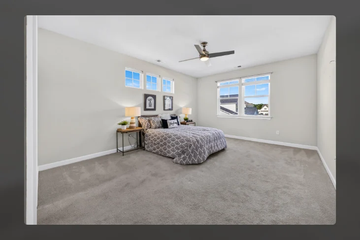 Bedroom with ceiling fan and large windows