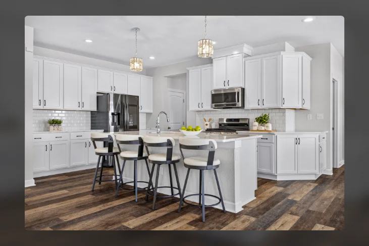 White kitchen cabinetry and island seating