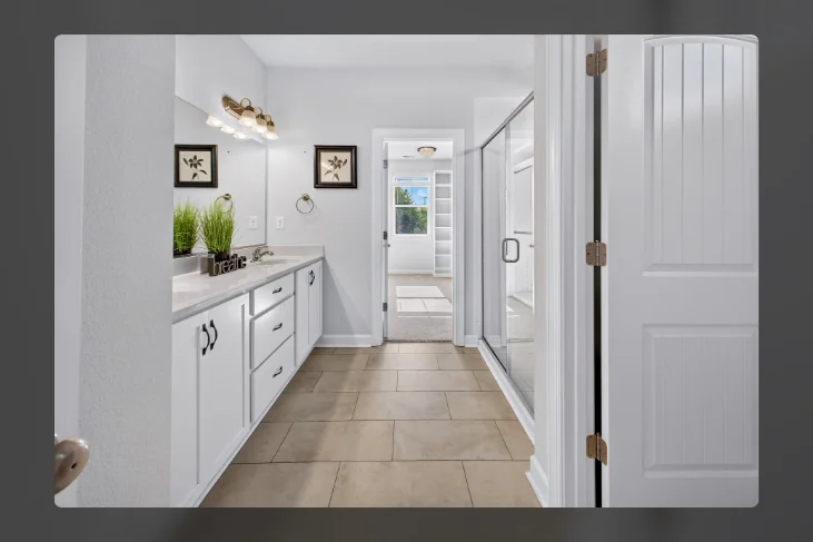 Bathroom with double vanity and a glass shower